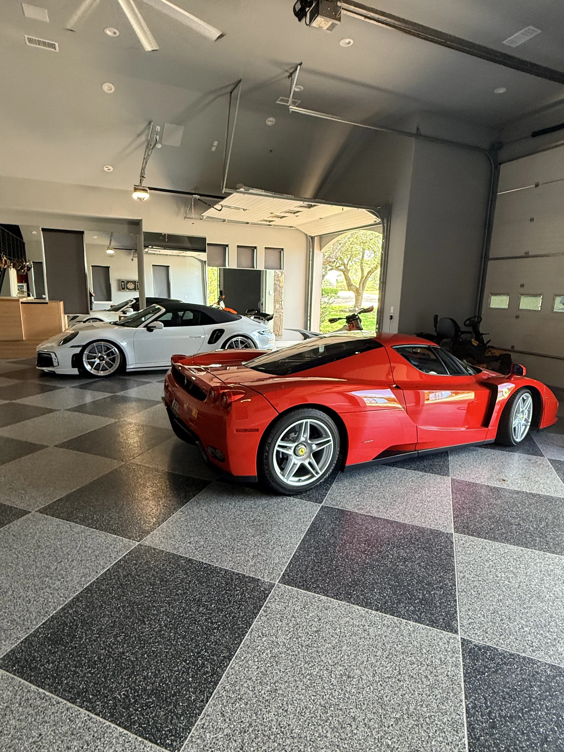 Ferrari Enzo and Porsche GT3 RS in a collector garage