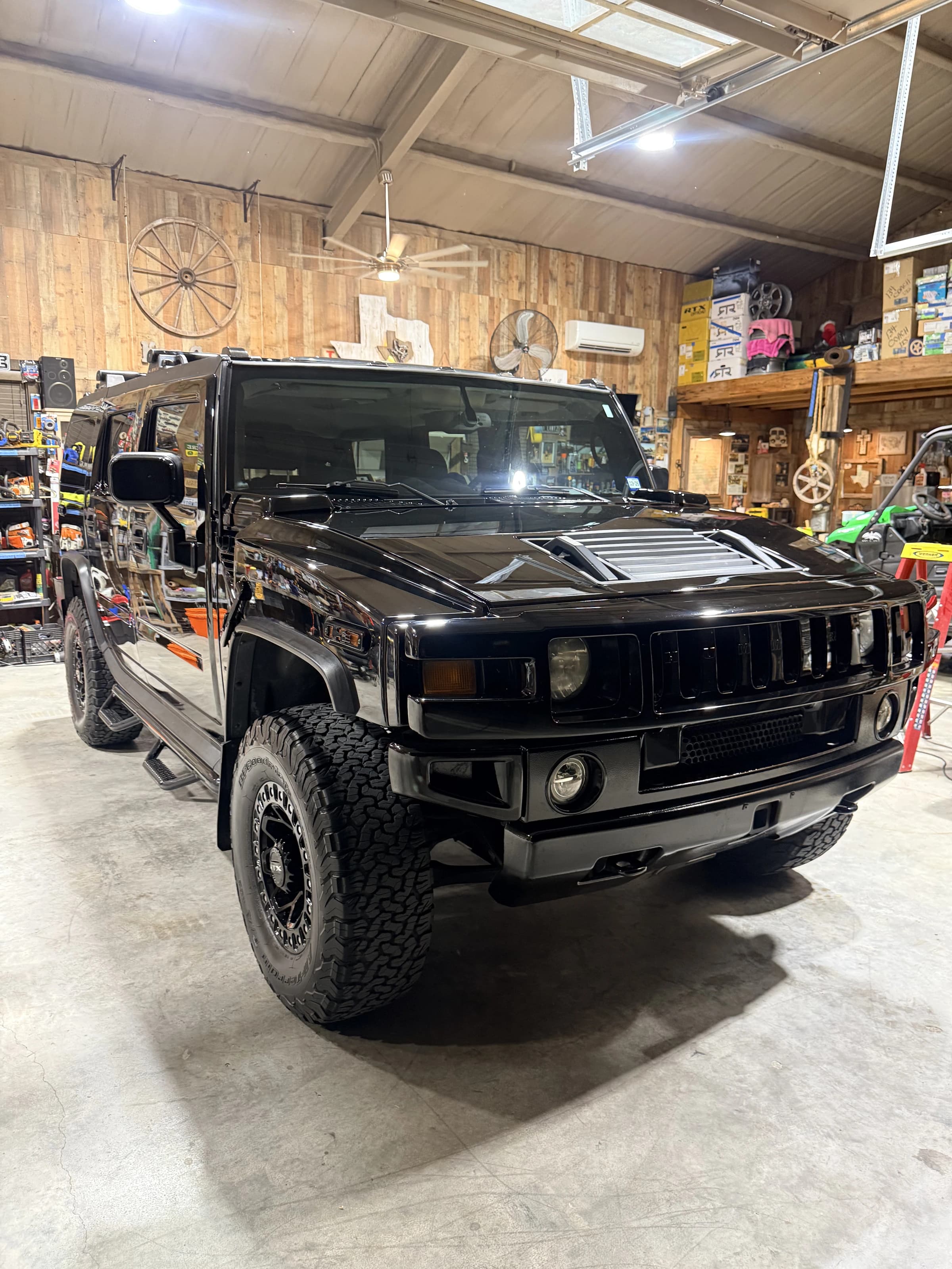 Black Hummer H2 detailed in a workshop