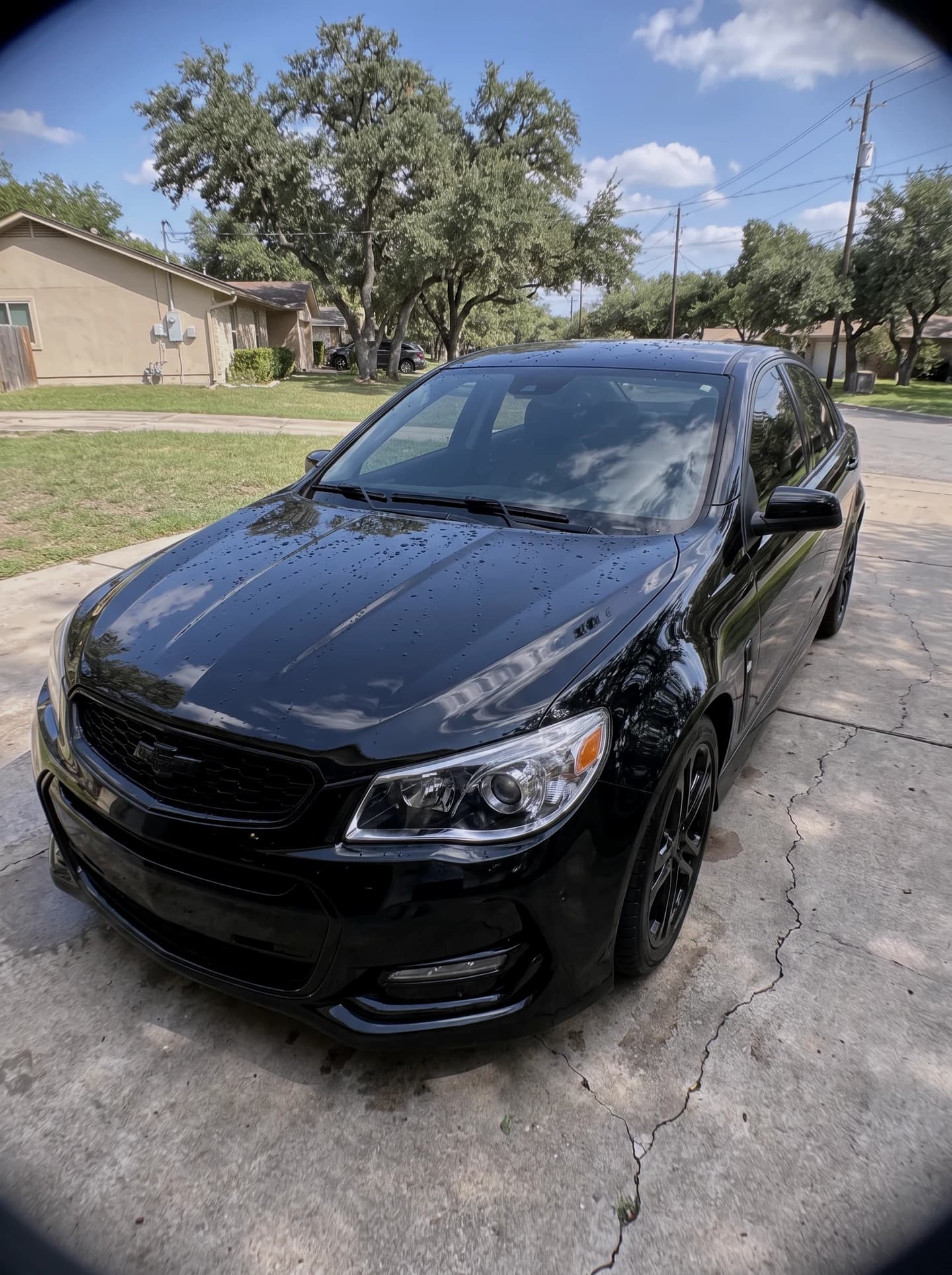 Black sedan with a fresh ceramic coating, deep gloss reflections