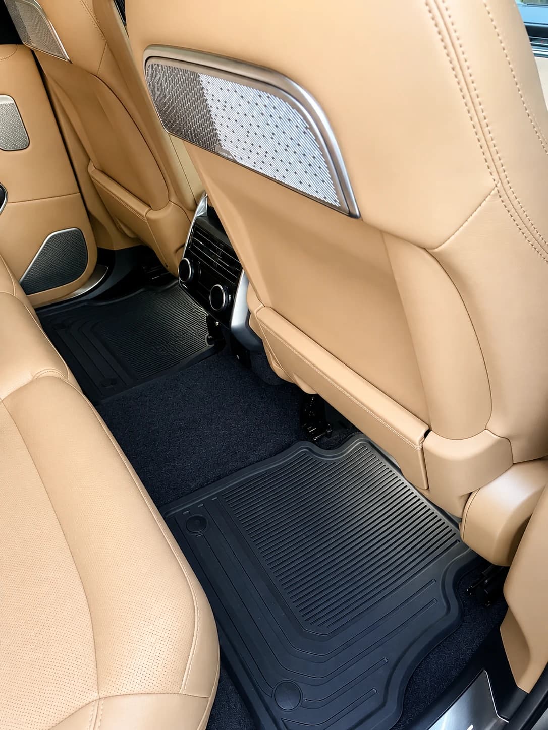 Clean rear footwell and floor mats in a luxury SUV
