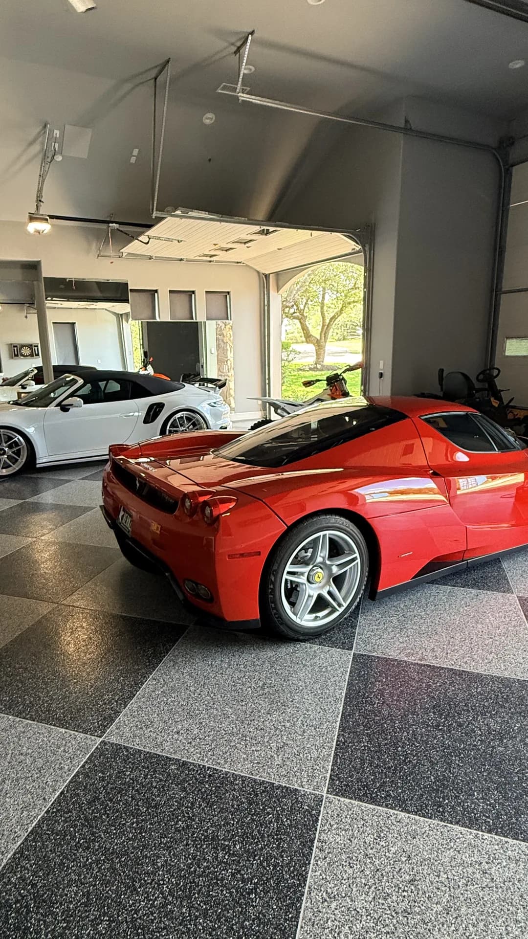 Ferrari Enzo and Porsche 911 Turbo S detailed in a collector garage