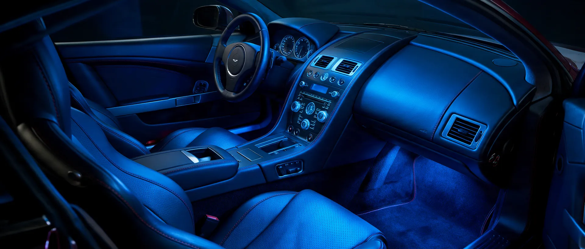 Inside the cabin, with the seats, dashboard, vents and carpet all lit in white.